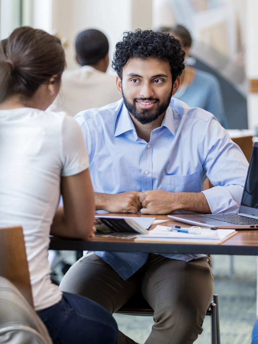 Couple sitting at table talking
